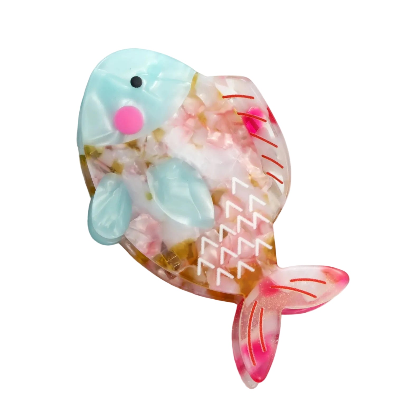 A fish-shaped resin hair clip or brooch with a light blue head, pink cheeks, and a translucent body filled with pink flower petals and gold glitter, resting on a white marble surface.