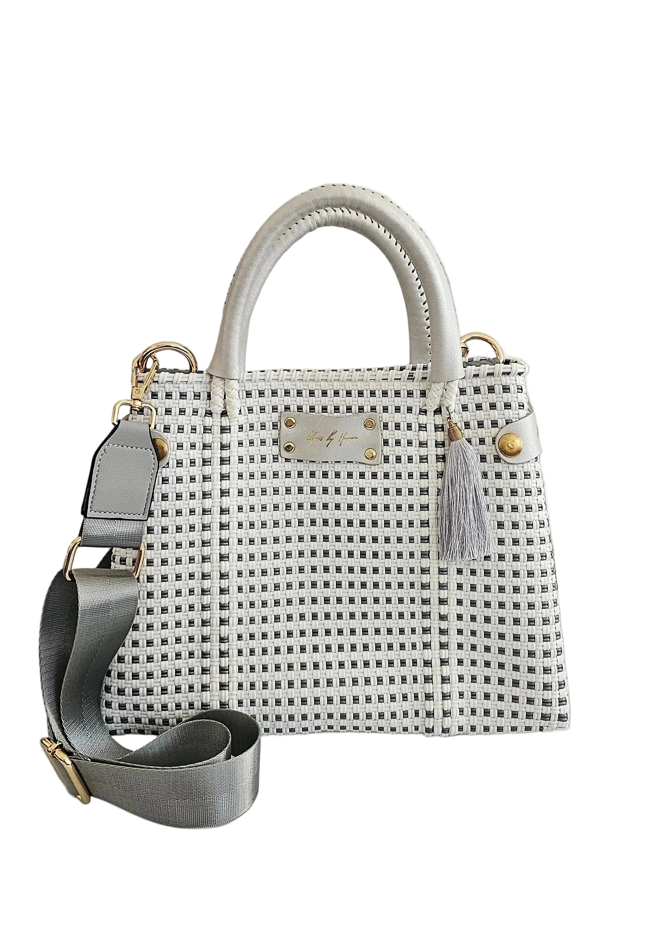 Artisan crossbody handbag with silver and white checkered pattern, featuring dual top handles, a matching shoulder strap, and gold-tone hardware.