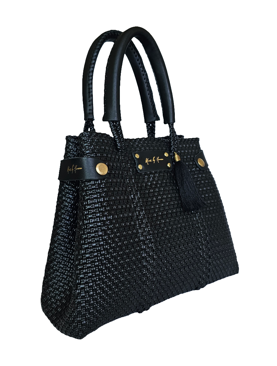 Sustainable black crossbody bag made from eco-friendly materials, transforms into a tote for versatile, ethical fashion