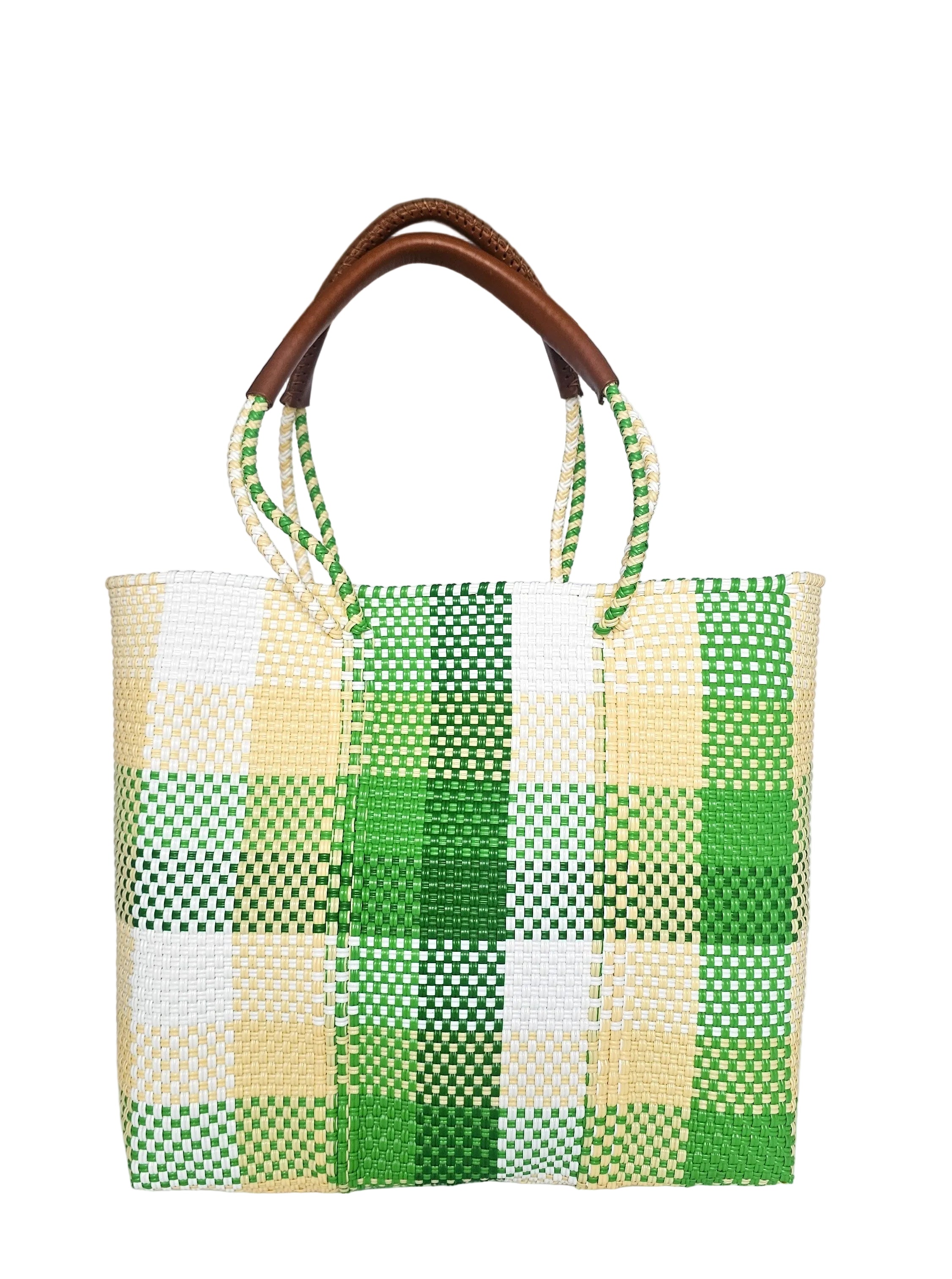 Green and white checkered bag with brown handles on a white surface
