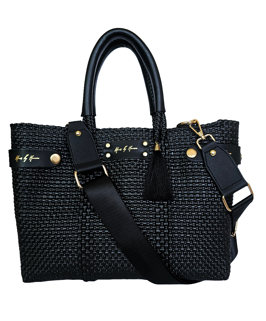 Sustainable black crossbody bag made from eco-friendly materials, transforms into a tote for versatile, ethical fashion