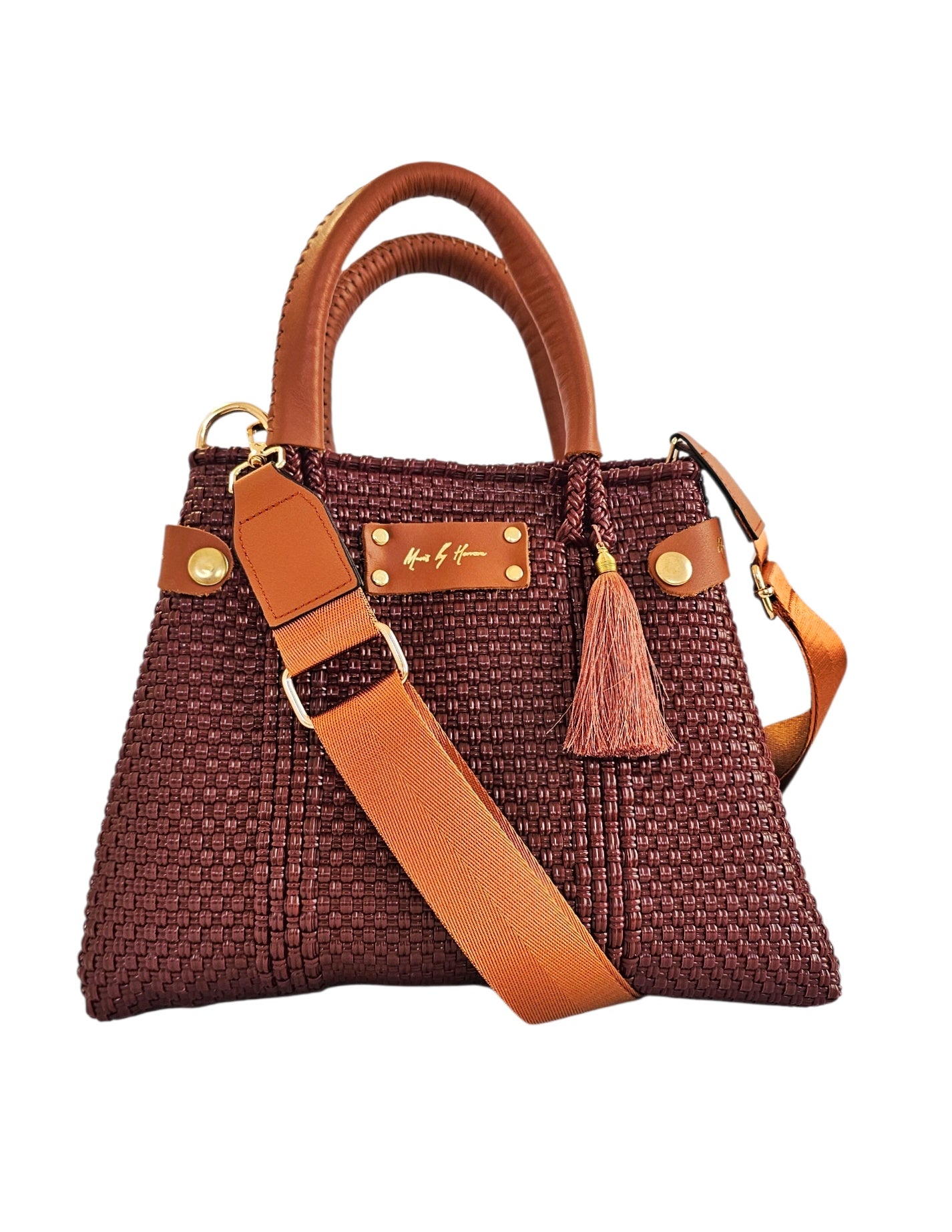 Handwoven crossbody bag with a mini tote bag in burgundy color with tan leather accents on a white background