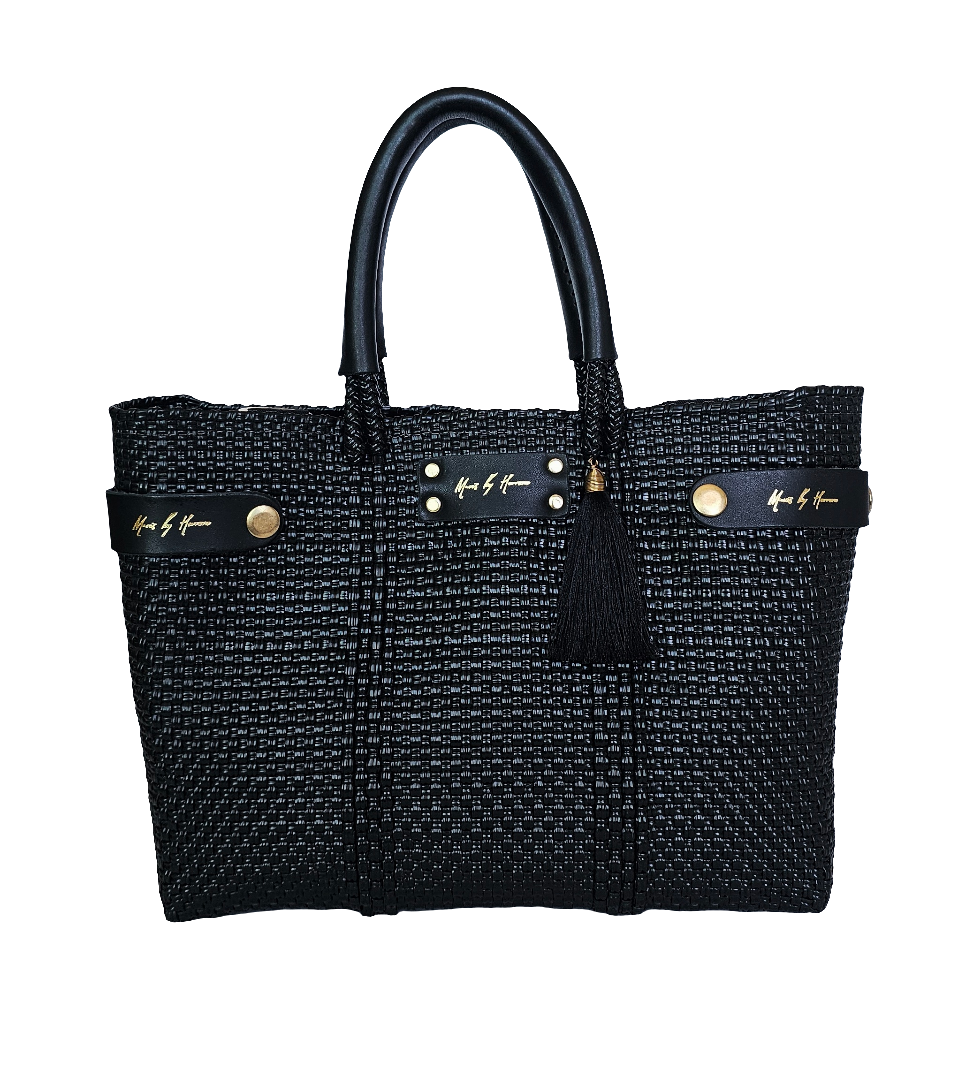 Sustainable black crossbody bag made from eco-friendly materials, transforms into a tote bag.