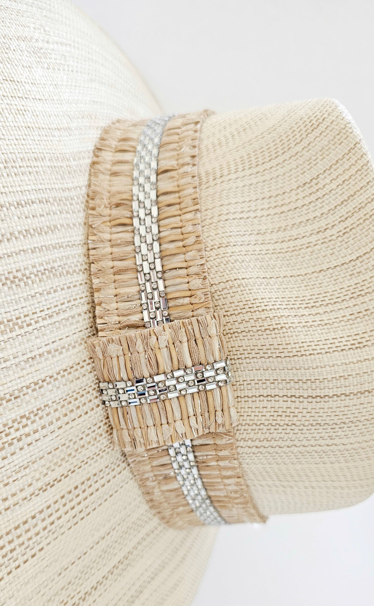 Crystalline Radiance Resort Hat: close-up of sparkling hatband on an ivory woven hat.