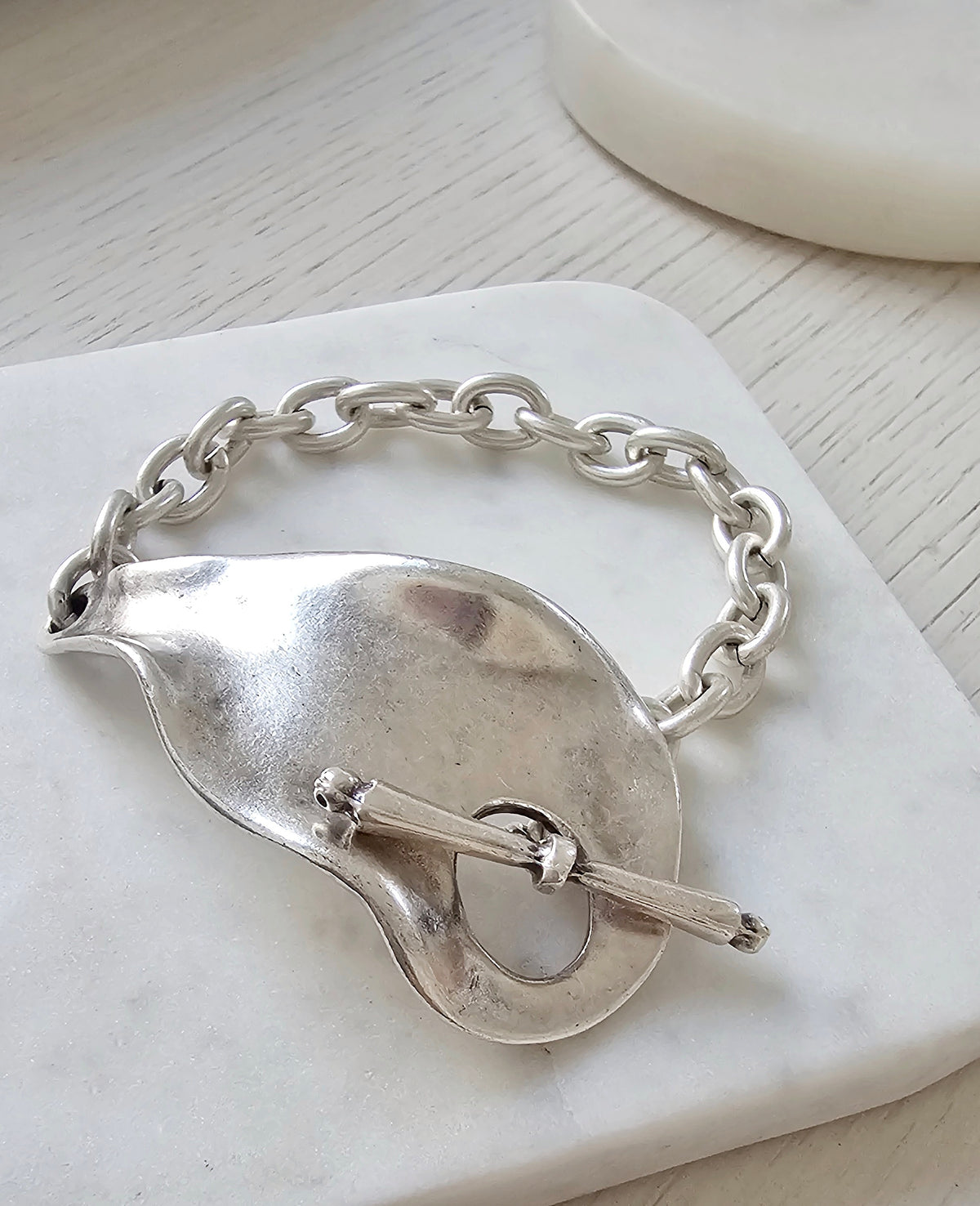 Eclat Bracelet: silver-tone sculptural chain bracelet with toggle closure.