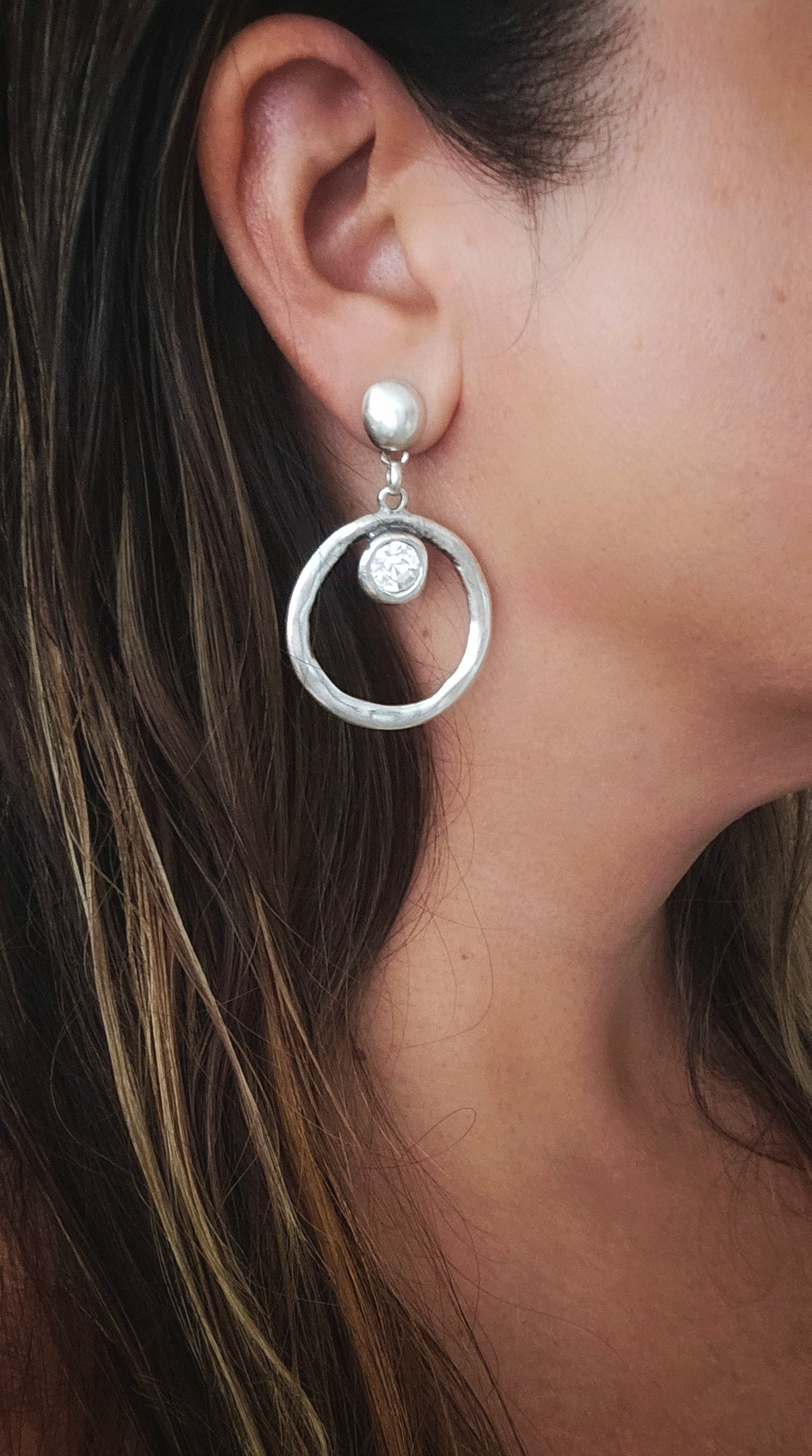 Infinity Crystal Earrings Hoops: model wearing silver-tone circular drop earrings.