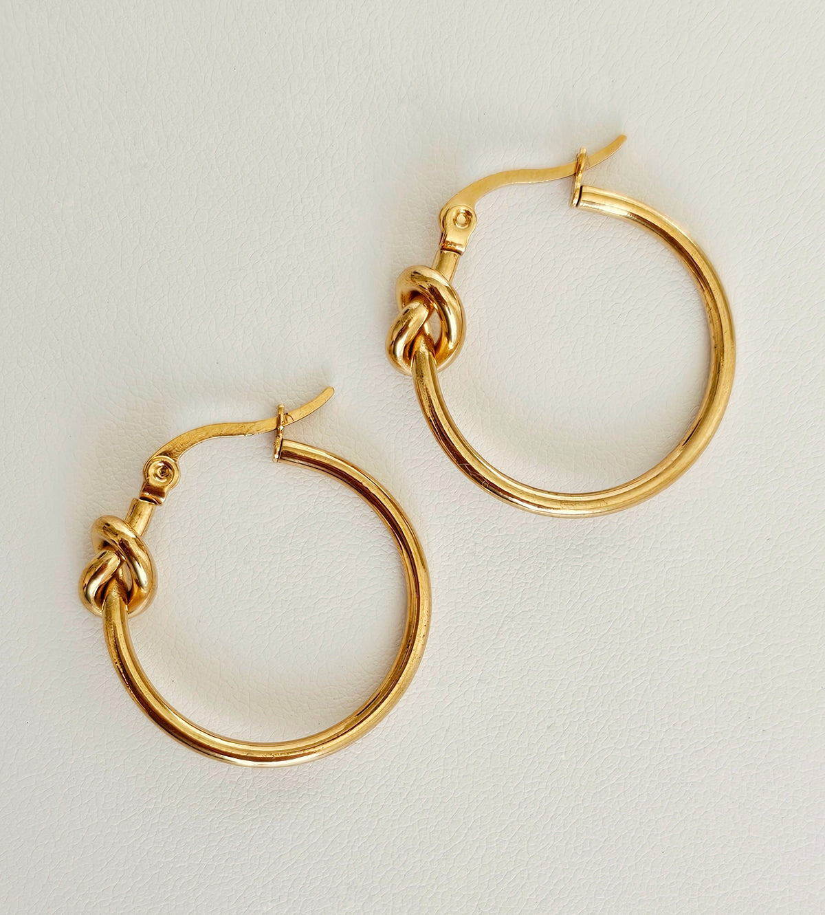 Love Knot Hoop Earrings: gold-tone knotted hoop earrings, full pair.