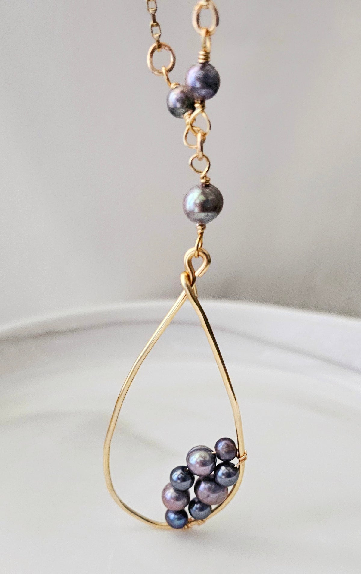 The Ava Baroque Pearl Necklace: close-up of long necklace with pearl and bead accents.