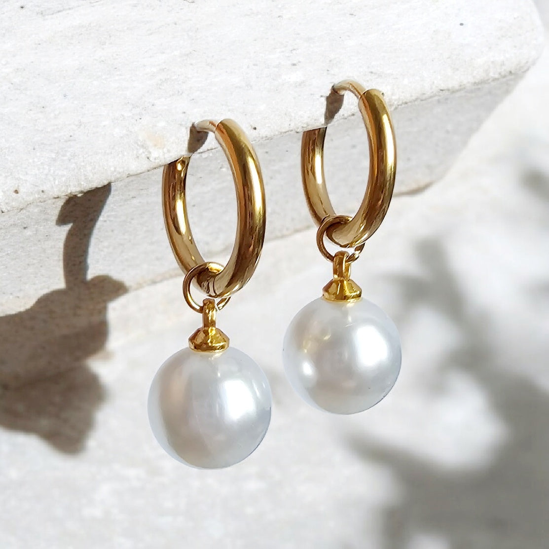 The Essential Pearl Earrings: gold-tone hoop earrings with round pearl drops.