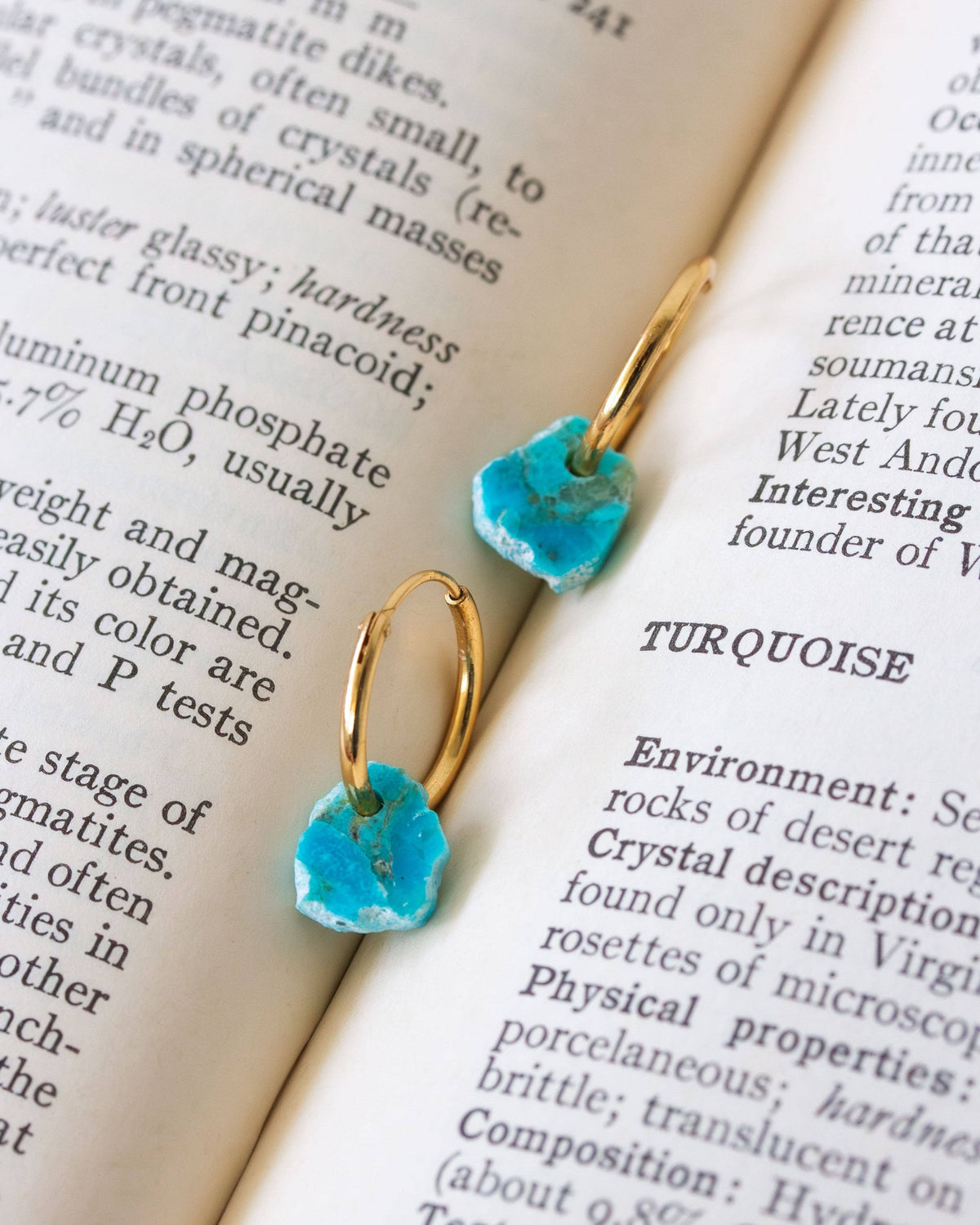 Turquoise Serenity Mini Hoop Earrings: turquoise stone mini hoop earrings displayed on printed paper.