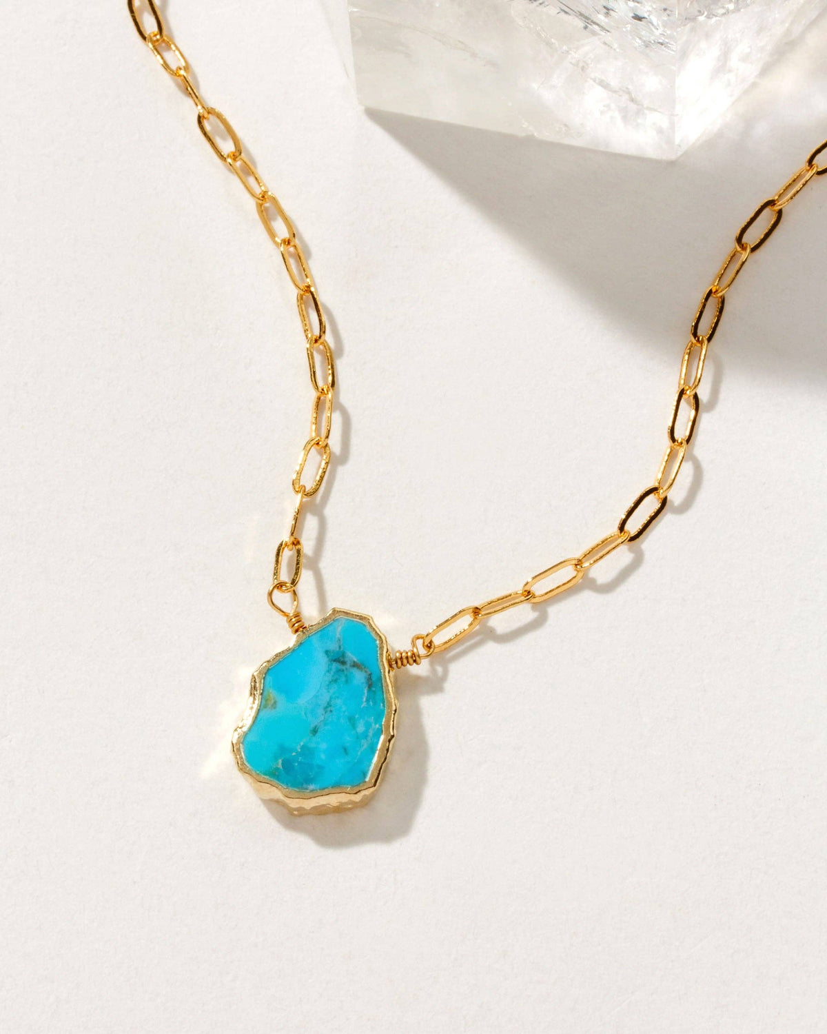 Turquoise Serenity Necklace: gold-tone chain necklace with turquoise pendant.