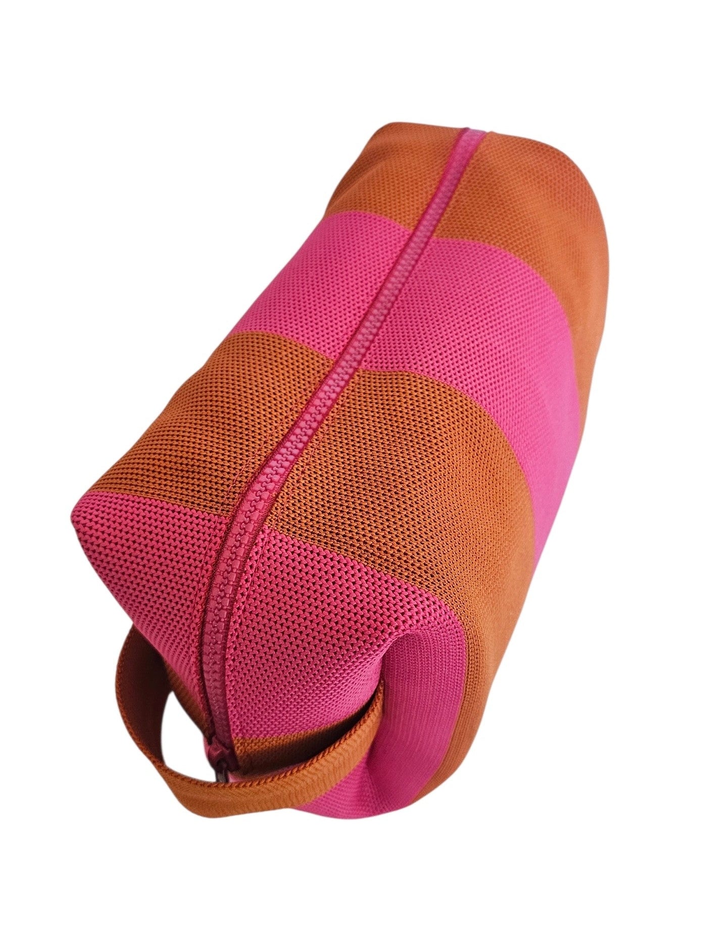A cosmetic pouch bag in pink and orange with zipper closure