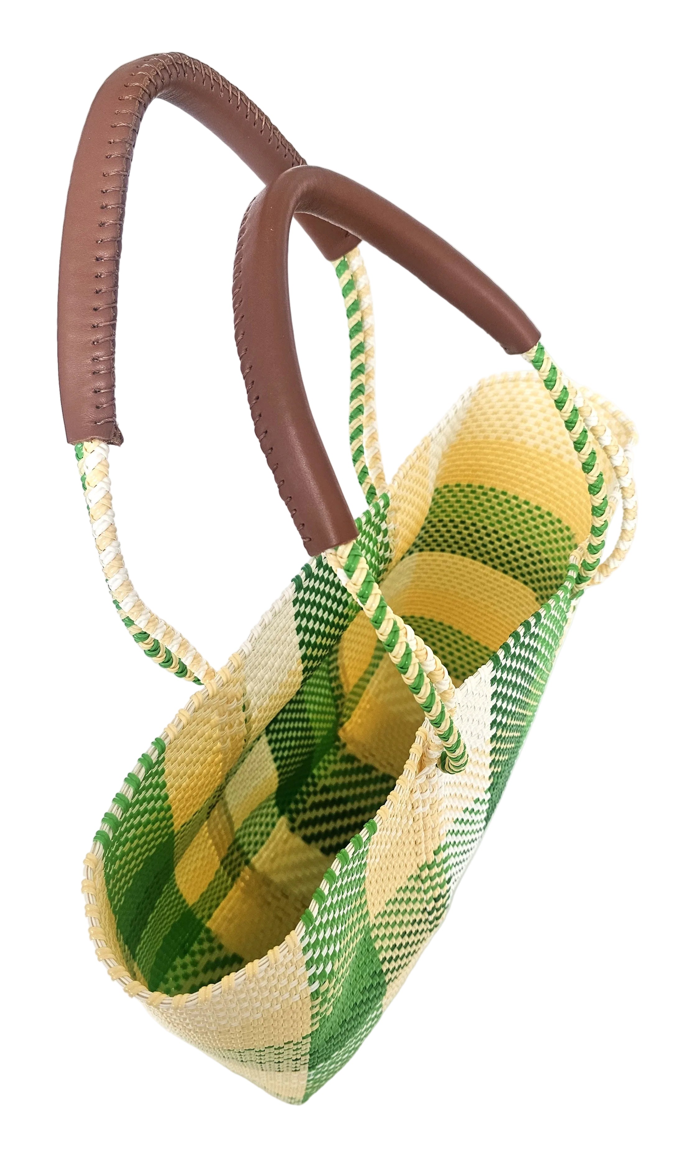 Woven basket with green and yellow pattern and brown handles on a white background