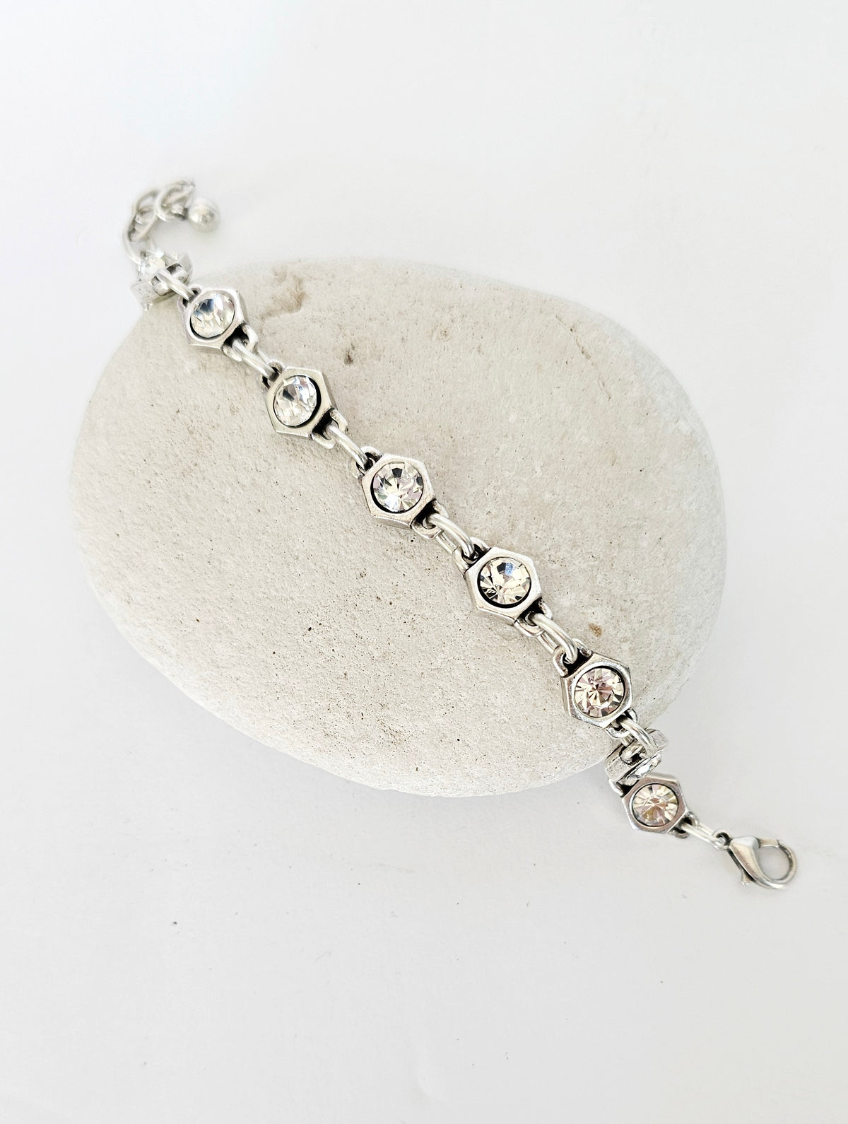 Crystal Perfection Bracelet: crystal-link bracelet draped over a display stone.