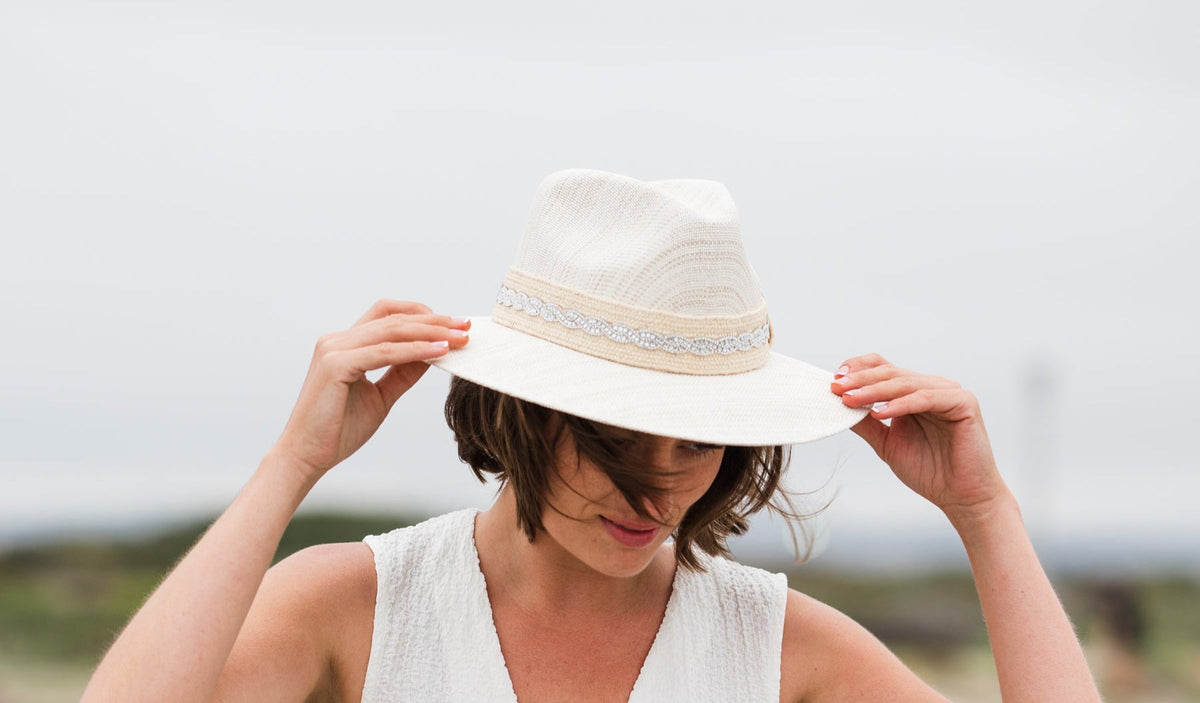 Crystalline Radiance Resort Hat: woman wearing an ivory resort fedora with sparkling hatband.
