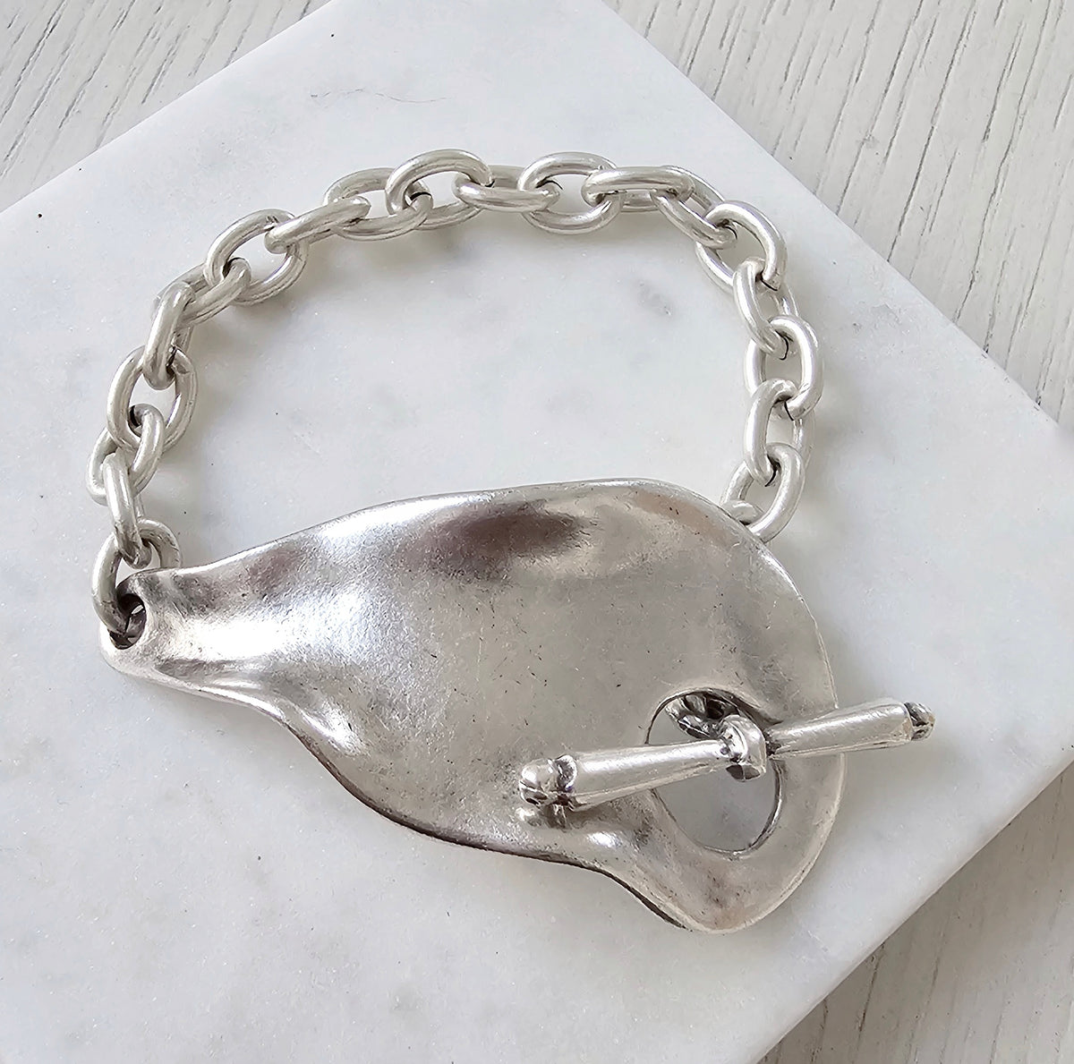 Eclat Bracelet: sculptural silver-tone chain bracelet, front view.