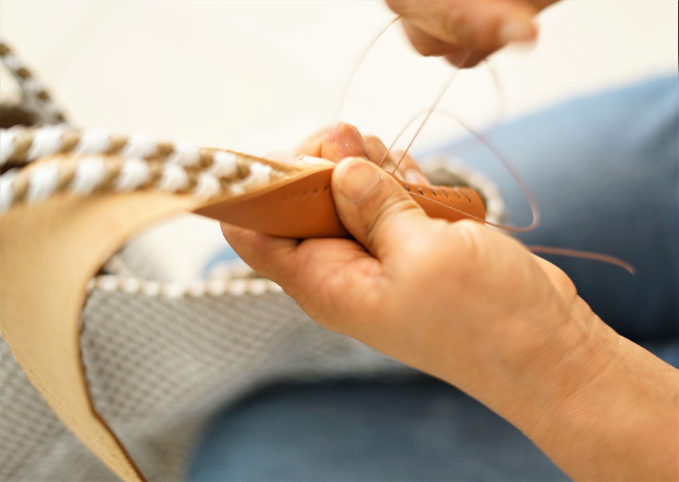 Artisan handweaving a sustainable Mavis by Herrera bag from recycled plastic