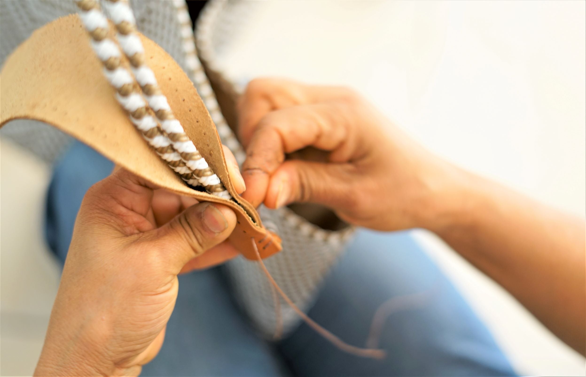 Artisan handweaving a Mavis by Herrera bag from recycled plastic