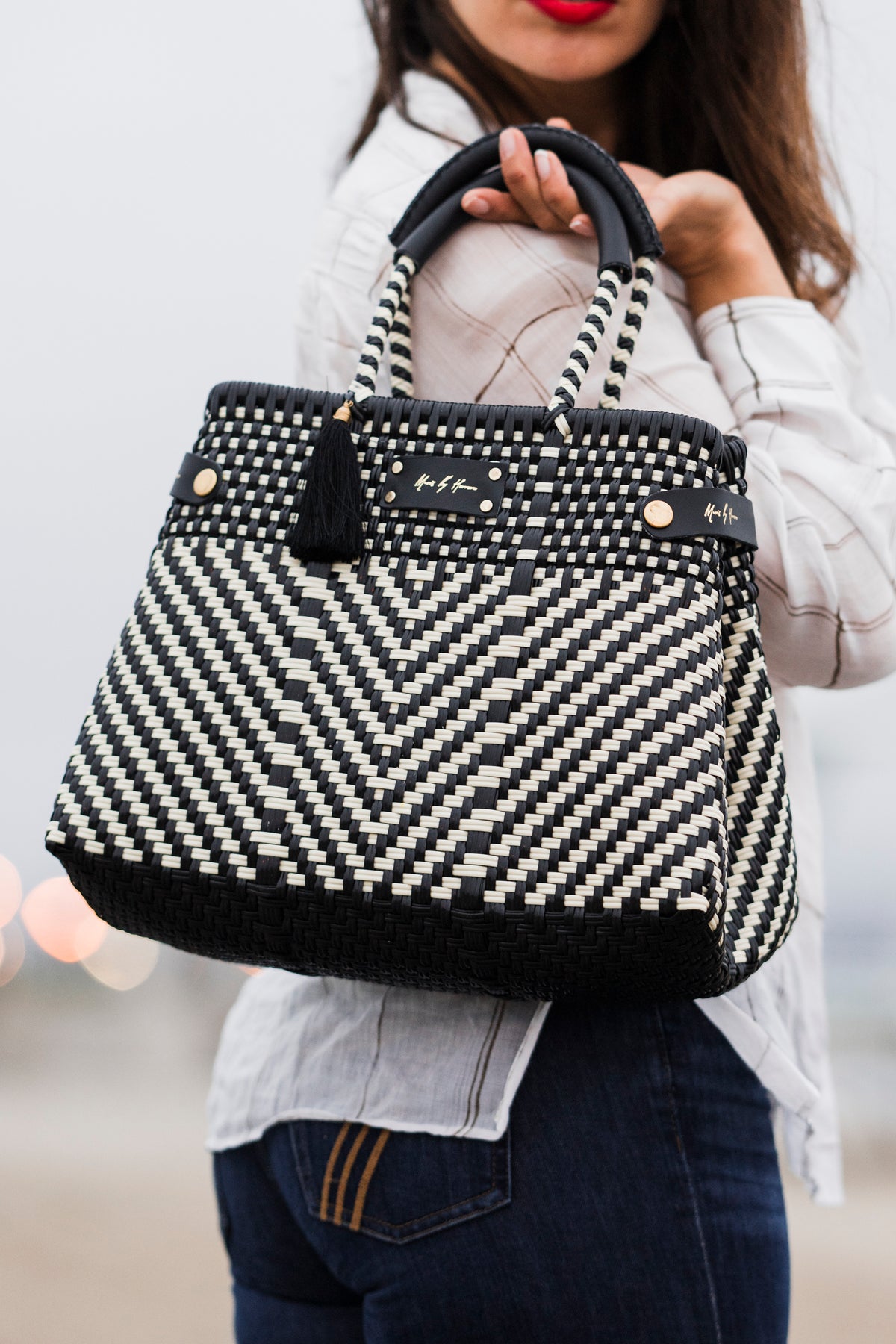 Less Pollution Convertible Handbag to Tote - Luxe Ivory Black: woman carrying an ivory and black chevron-woven convertible handbag.