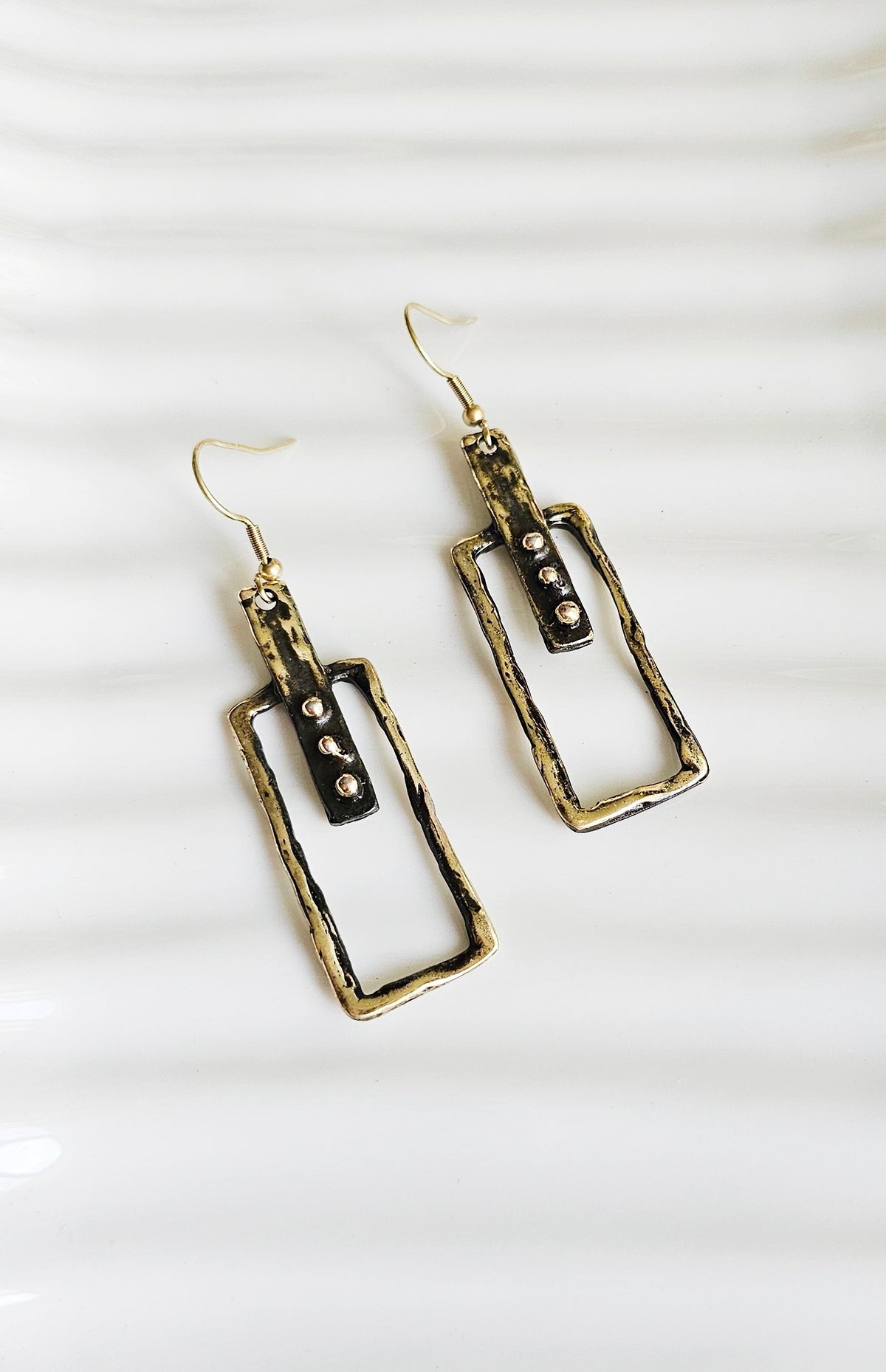 Linear Earrings: slim rectangular drop earrings with mixed-metal accents, front view.