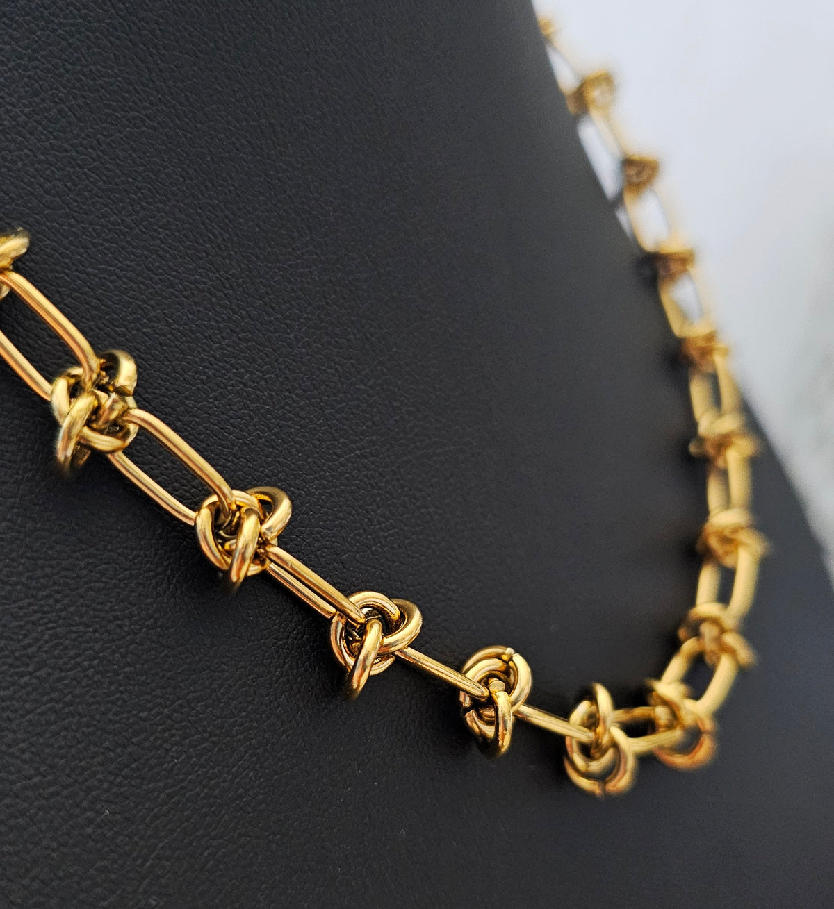 Luxe Knot Necklace: gold-tone knot-link necklace, detail view.
