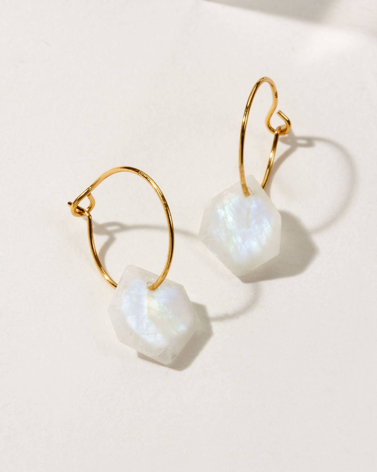 Moonstone Serenity Mini Hoop Earrings: gold-tone mini hoop earrings with pale stone drops.