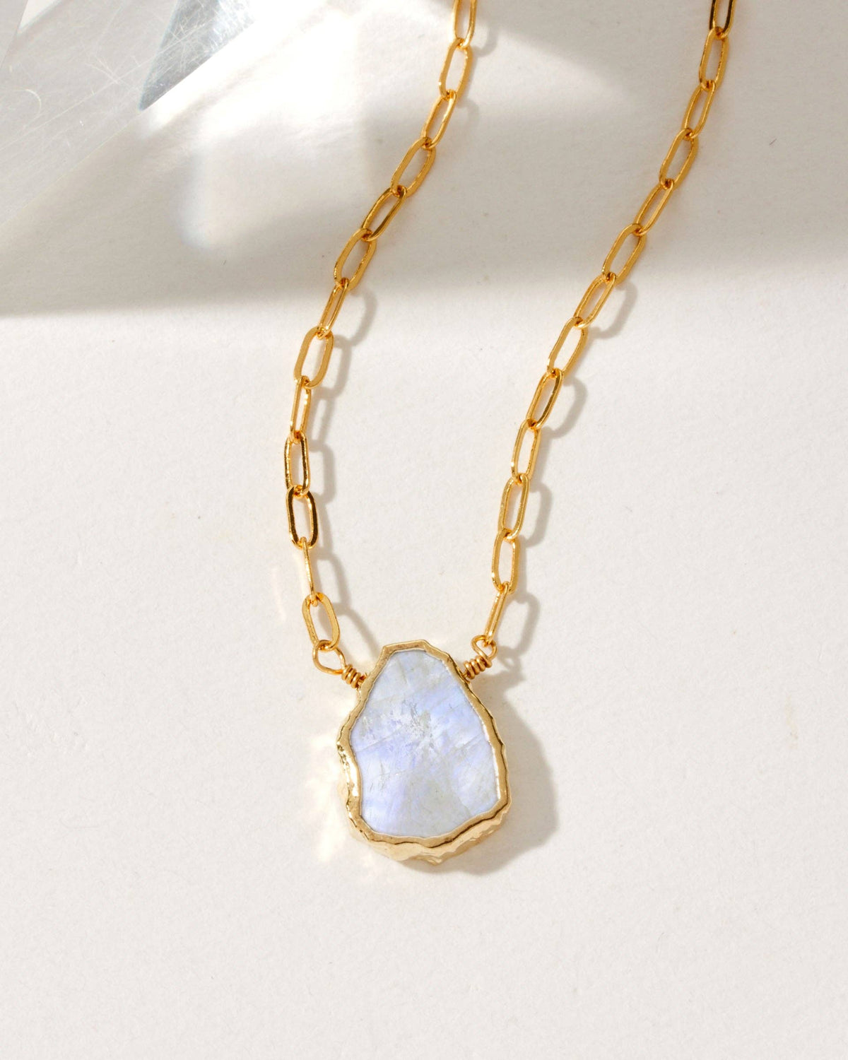 Moonstone Serenity Necklace: gold-tone chain necklace with pale stone pendant.