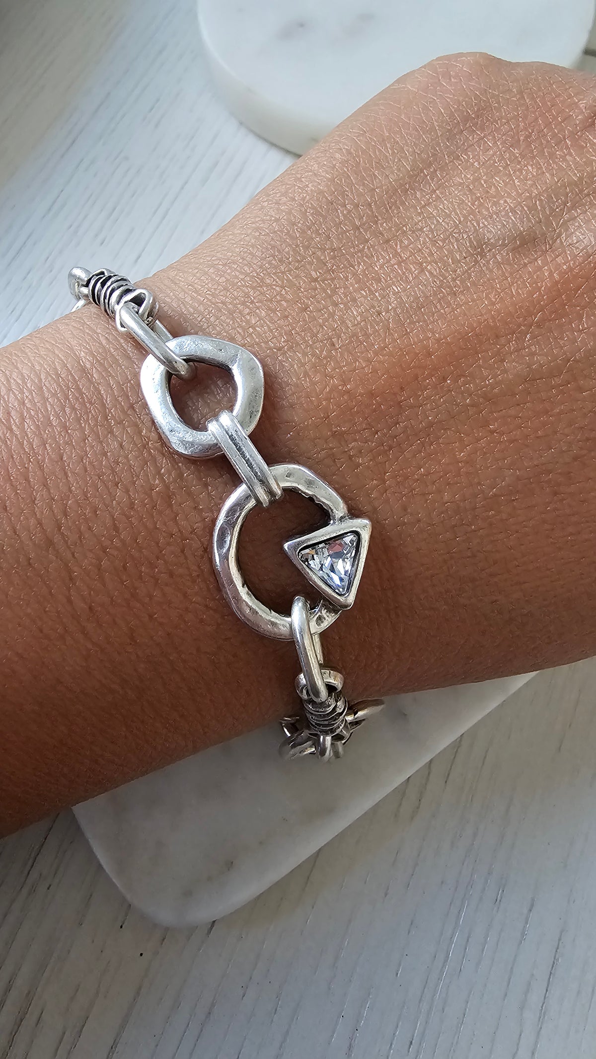 Prisma Bracelet: model wearing a silver-tone geometric-link bracelet.