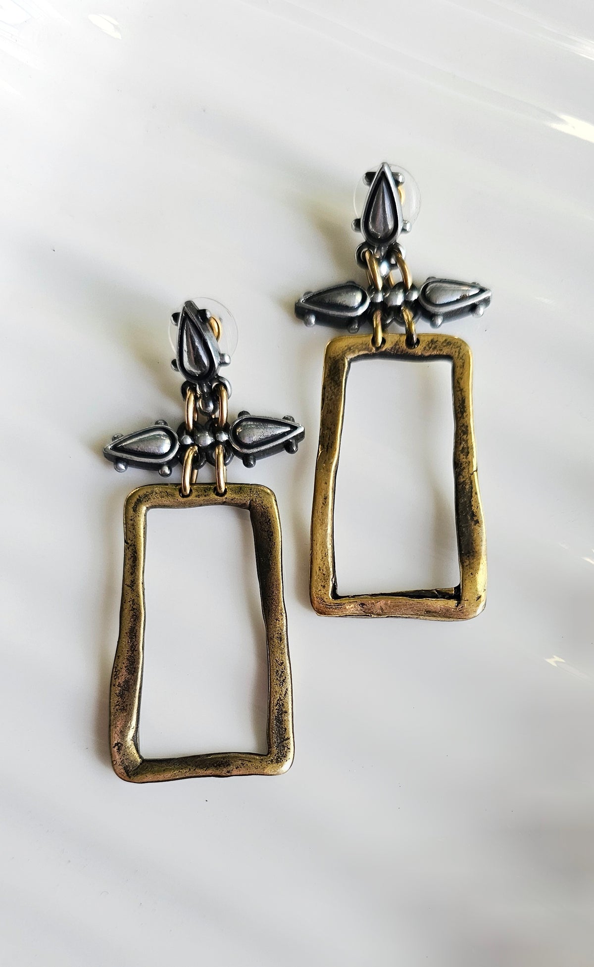 Sculpted Elegance Earrings: rectangular open-frame earrings with mixed-metal details, front view.