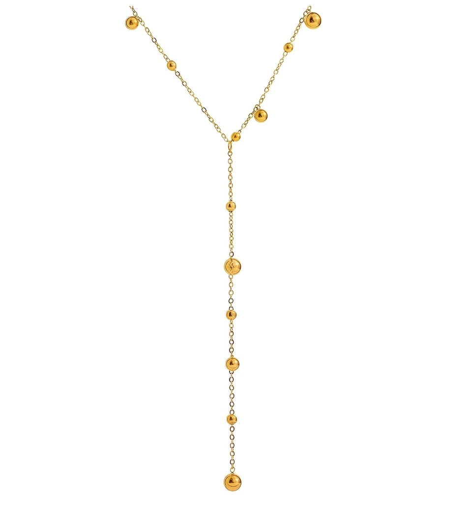 The Line Drop Necklace: gold-tone lariat necklace with small bead accents, full view.