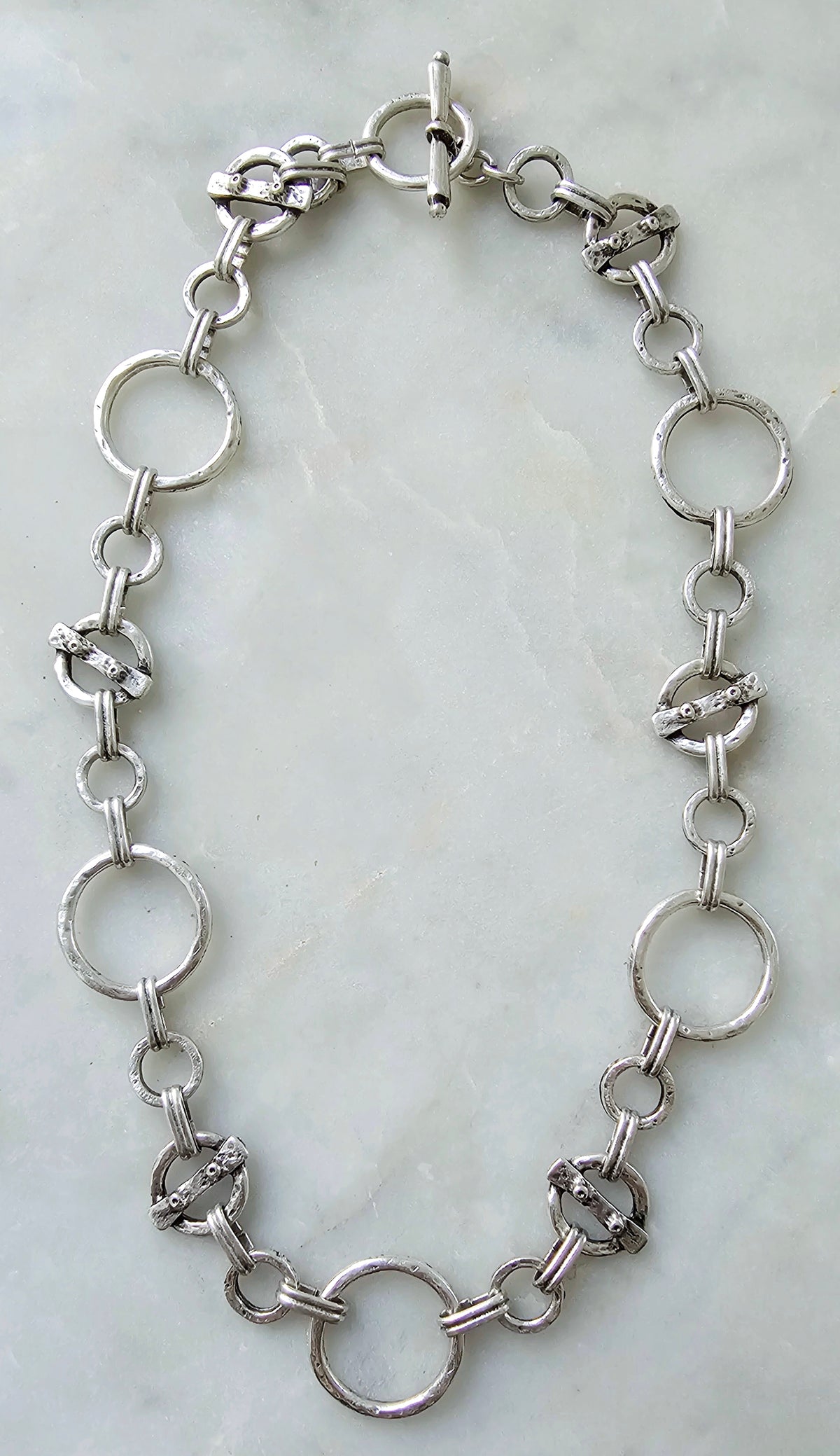 The Solenne Necklace and Bracelet Set: silver-tone linked necklace, full view.