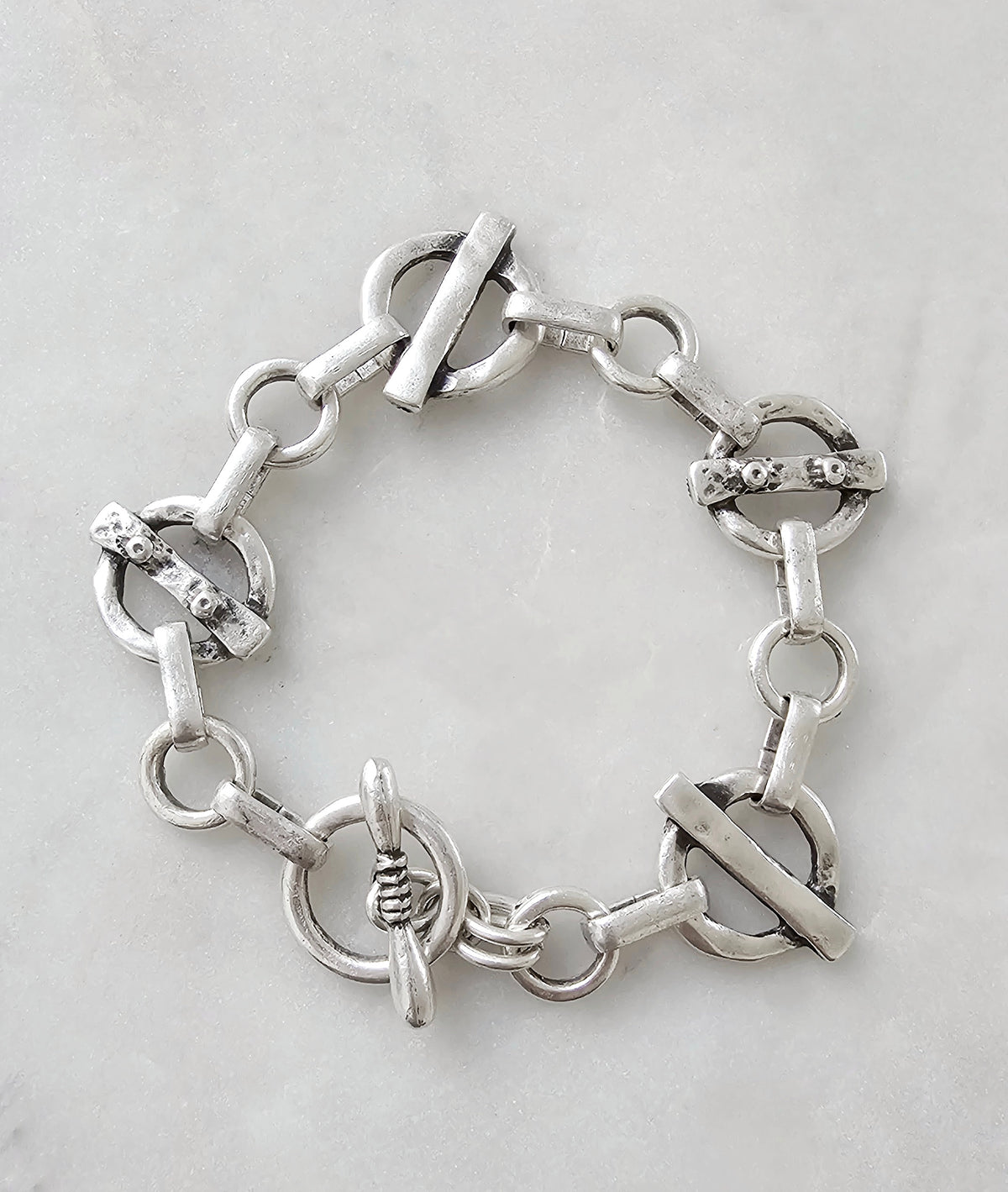 The Solenne Necklace and Bracelet Set: silver-tone linked bracelet with toggle clasp.