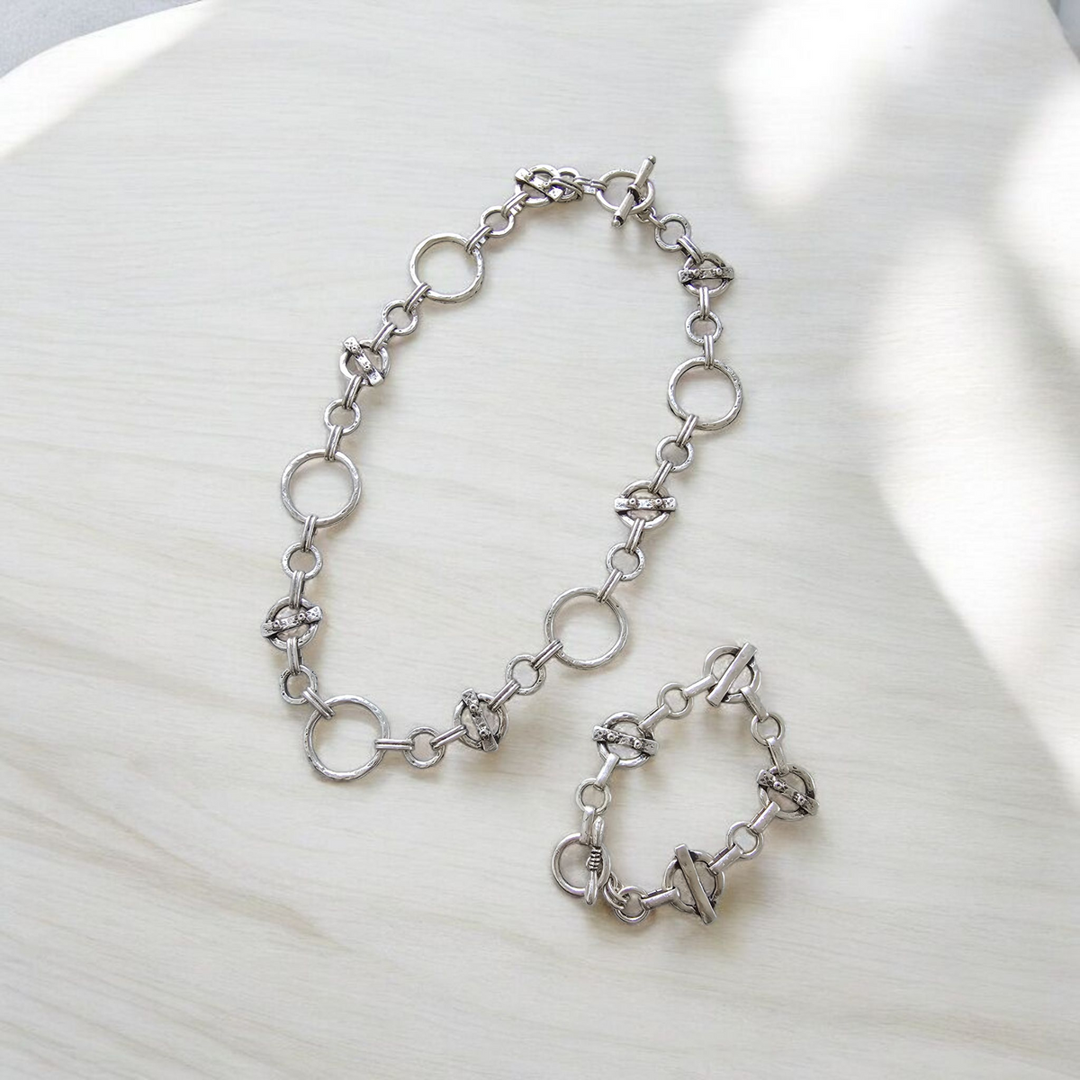 The Solenne Necklace and Bracelet Set: silver-tone necklace and bracelet set displayed together.