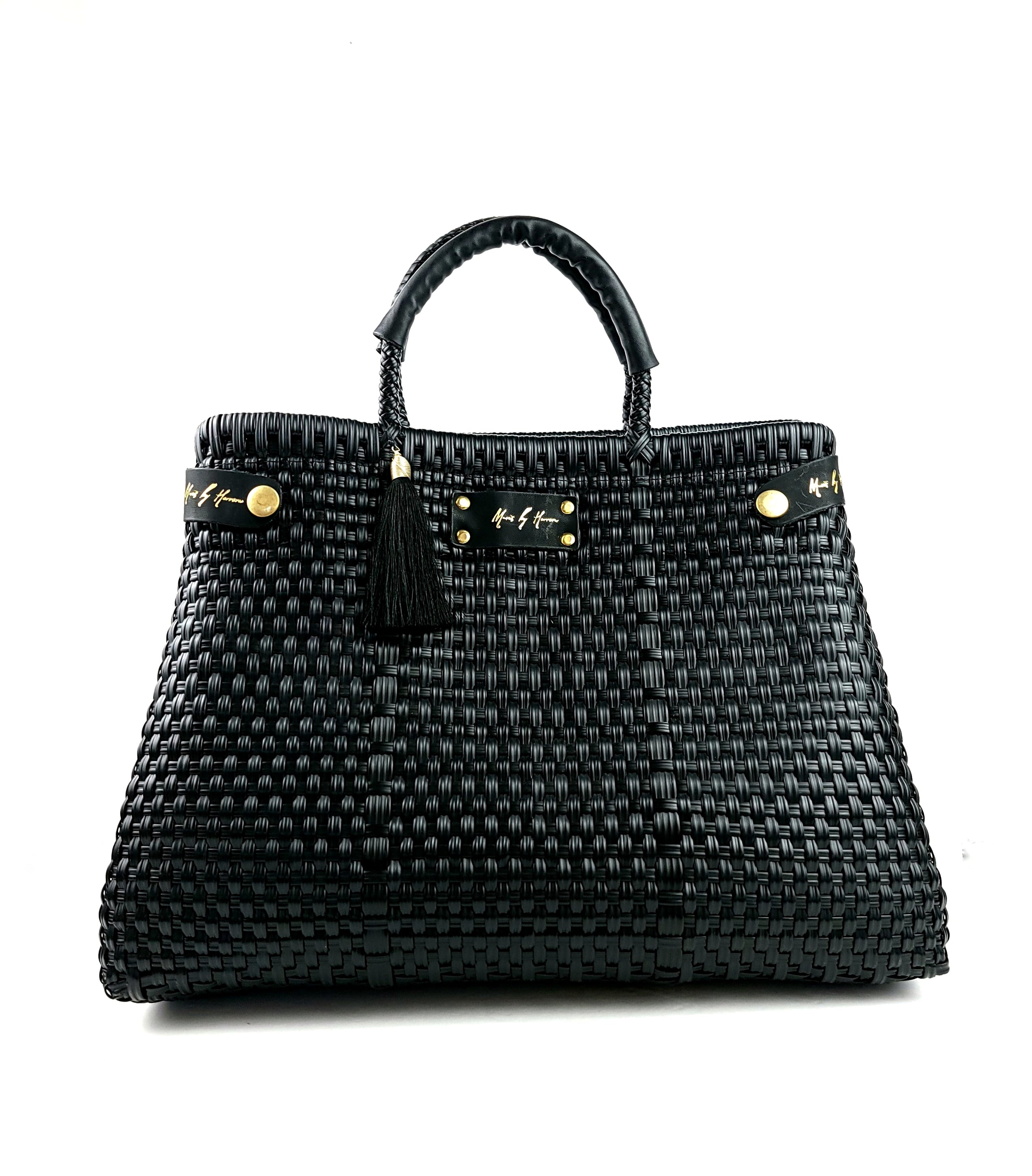 A luxury handbag in black, sustainably crafted from ethically sourced and recycled plastic and leather.