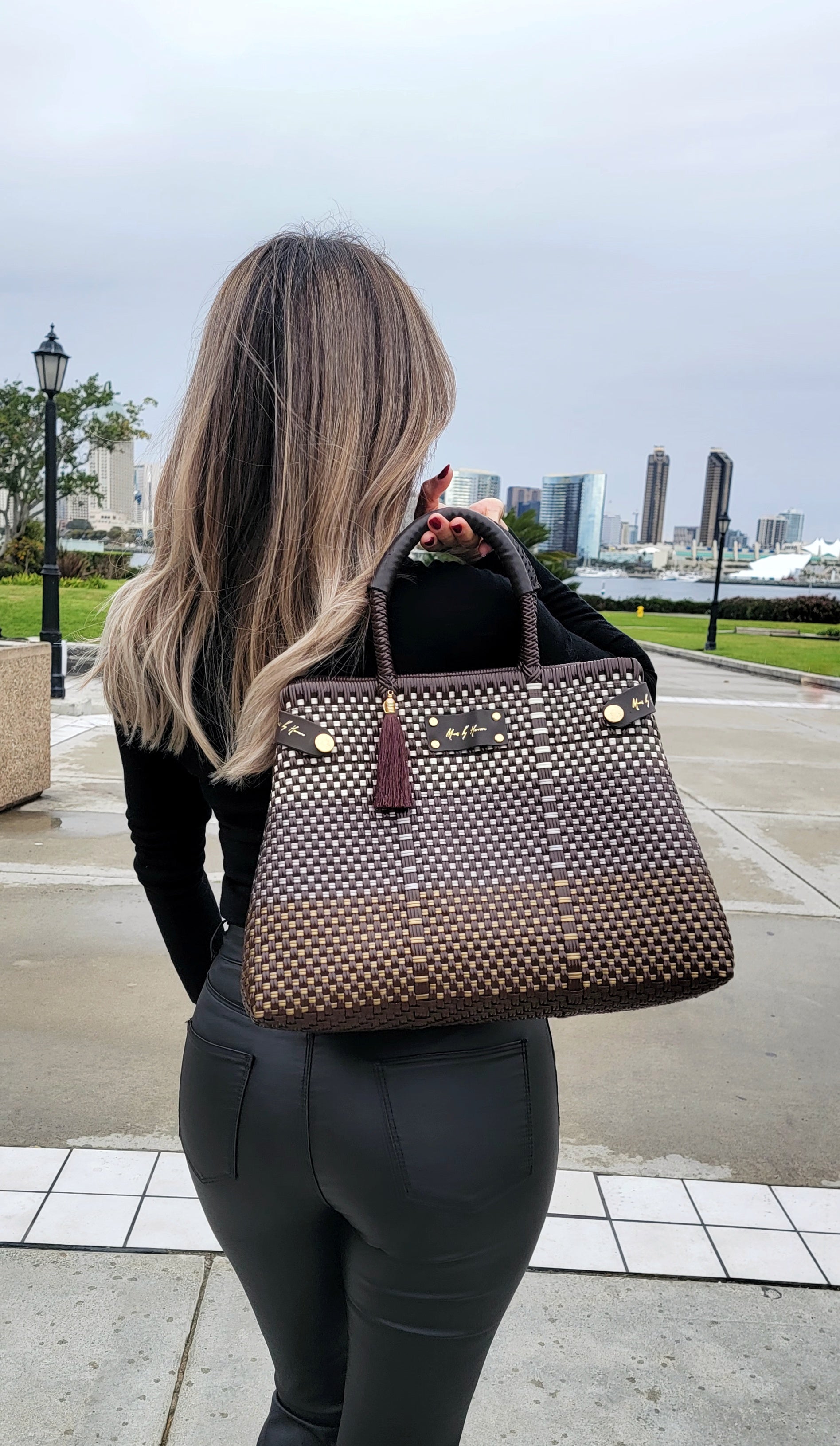 Luxury sustainable handbag in color brown made from recycled plastic and leather, with a convertible tote design