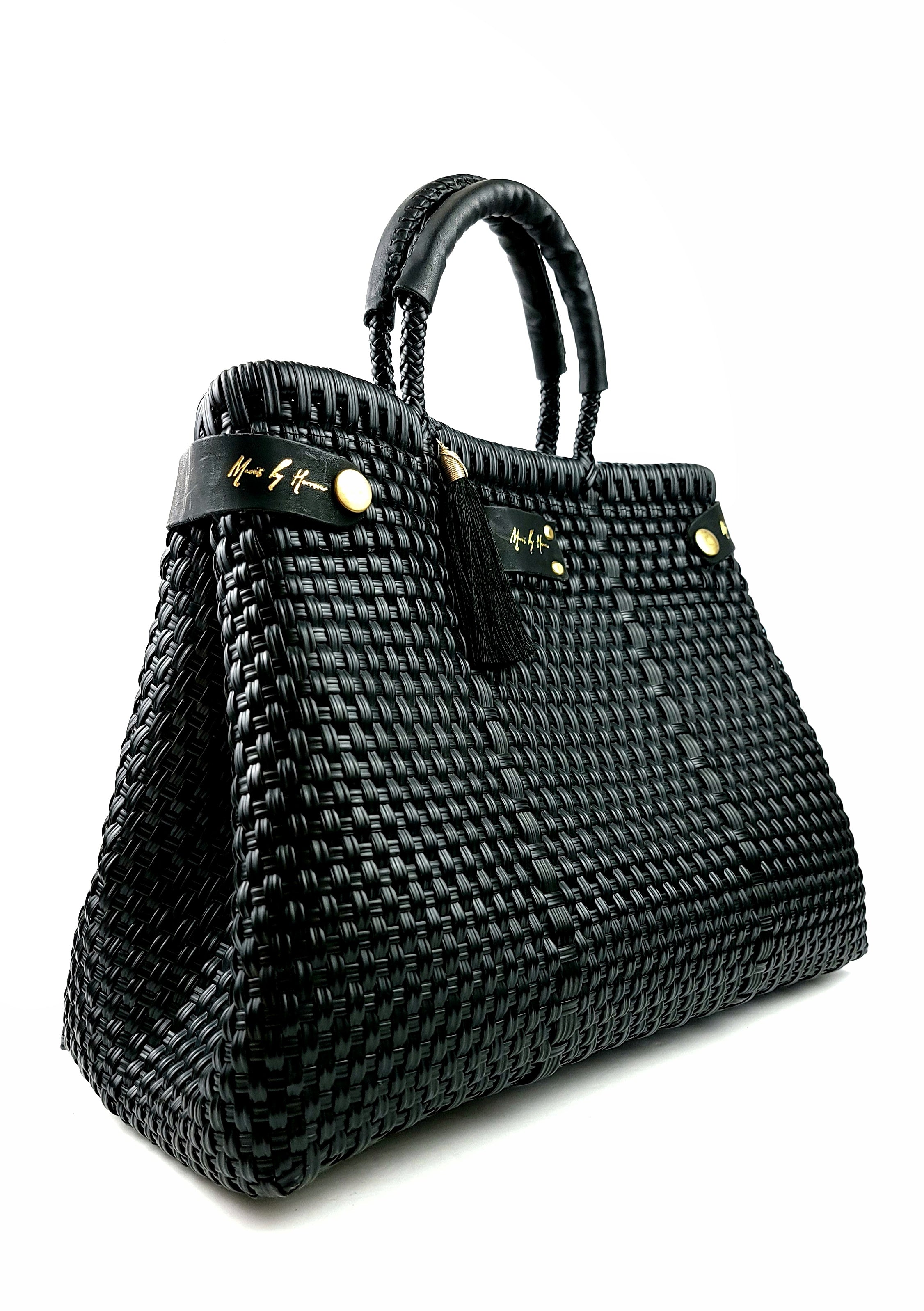 A luxury black handbag, sustainably crafted from ethically sourced and recycled plastic and leather.